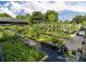 Backyard with raised garden beds, vertical planters, and a variety of vegetables growing in the sun at 22106 Garmisch Way, Brooksville, FL 34601