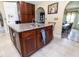 Kitchen island features granite countertop, custom cabinets and faucet and view of dining room at 22106 Garmisch Way, Brooksville, FL 34601