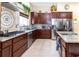 Spacious kitchen with stainless steel appliances, granite countertops, tile backsplash and custom cabinetry at 22106 Garmisch Way, Brooksville, FL 34601