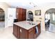 Kitchen island with sink and granite countertop and ample storage at 22106 Garmisch Way, Brooksville, FL 34601