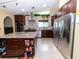 Spacious kitchen with modern appliances, cherry cabinets, and granite countertops at 22106 Garmisch Way, Brooksville, FL 34601