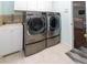 Convenient laundry room with modern washer and dryer units and a utility sink at 22106 Garmisch Way, Brooksville, FL 34601