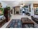 Bright open floor plan living room boasts fireplace, mounted tv, leather couch and lots of decor at 22106 Garmisch Way, Brooksville, FL 34601