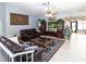 Cozy living room featuring a comfortable leather sofa, patterned rug, and decorative accents at 22106 Garmisch Way, Brooksville, FL 34601