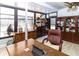 Comfortable office featuring a large desk, leather chair, and view to the pool at 22106 Garmisch Way, Brooksville, FL 34601