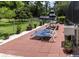 Backyard patio area featuring a picnic table, lounge chairs, and outdoor sink at 22106 Garmisch Way, Brooksville, FL 34601
