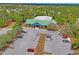 Aerial view of clubhouse featuring well-kept green lawn and ample parking on a sunny day at 3032 Jacob Crossing Ln, Holiday, FL 34691