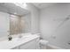 This bathroom features a sink with white cabinets, a large mirror, beige tiling, and modern fixtures at 3032 Jacob Crossing Ln, Holiday, FL 34691