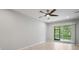 Bedroom featuring neutral walls, tile flooring, ceiling fan, and sliding glass doors to the lanai at 3032 Jacob Crossing Ln, Holiday, FL 34691