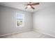 Bedroom with a window that provides natural light and neutral carpet at 3032 Jacob Crossing Ln, Holiday, FL 34691