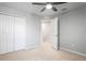 Bedroom with a ceiling fan, large closet, light carpet, and neutral colored walls at 3032 Jacob Crossing Ln, Holiday, FL 34691