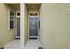 Charming entryway featuring decorative wreath on front door and welcome mats on both entryways at 3032 Jacob Crossing Ln, Holiday, FL 34691