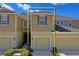 Two-story townhome featuring an attached garage, neutral siding, and well-maintained landscaping at 3032 Jacob Crossing Ln, Holiday, FL 34691