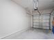 Bright and clean attached garage with concrete floor and functional overhead door at 3032 Jacob Crossing Ln, Holiday, FL 34691