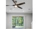 Living room featuring a ceiling fan and sliding glass doors leading to the lanai at 3032 Jacob Crossing Ln, Holiday, FL 34691