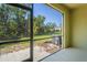 Relax on this screened patio with a view of the lush green lawn and mature trees, stone pavers on the floor at 3032 Jacob Crossing Ln, Holiday, FL 34691