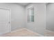 This room has a neutral color scheme, a window with blinds, and tile flooring at 3032 Jacob Crossing Ln, Holiday, FL 34691