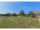 Fenced backyard with ample green space and mature landscaping at 3345 Carmen Ave, Spring Hill, FL 34609