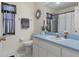 Bright bathroom features a blue countertop vanity and decorative mirror at 3345 Carmen Ave, Spring Hill, FL 34609