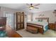 Spacious bedroom features carpet flooring, a ceiling fan, and an ornate wardrobe at 3345 Carmen Ave, Spring Hill, FL 34609