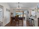 Open dining area features hardwood floors, a chandelier, and sliding glass doors to a screened patio at 3345 Carmen Ave, Spring Hill, FL 34609