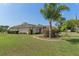 Charming single-story home with a well-manicured lawn, classic architectural details, and an attached two-car garage at 3345 Carmen Ave, Spring Hill, FL 34609