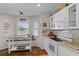 Bright kitchen features white cabinetry, stainless steel appliances, and a breakfast nook at 3345 Carmen Ave, Spring Hill, FL 34609