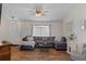 Inviting living room featuring wood floors, neutral paint, stylish decor, and a ceiling fan at 3345 Carmen Ave, Spring Hill, FL 34609
