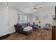 Inviting living room featuring wood floors, neutral paint, stylish decor, and a ceiling fan at 3345 Carmen Ave, Spring Hill, FL 34609