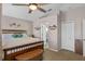 Bright main bedroom featuring a ceiling fan, carpeted floors, and ensuite bathroom at 3345 Carmen Ave, Spring Hill, FL 34609
