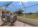 The outdoor patio features a dining table set, screened enclosure, and clear views at 3345 Carmen Ave, Spring Hill, FL 34609