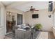 The covered patio includes outdoor seating, ceiling fan, and mounted television at 3345 Carmen Ave, Spring Hill, FL 34609