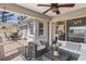 The outdoor patio has a ceiling fan, chairs and table for outdoor dining at 3345 Carmen Ave, Spring Hill, FL 34609