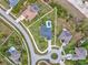 An aerial view of a property with a private pool, surrounded by lush greenery and neighborhood homes at 3455 Whispy Ct, Spring Hill, FL 34609