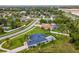 Aerial view showcasing a well-maintained home with a pool, fenced-in backyard, and lush green landscaping at 3455 Whispy Ct, Spring Hill, FL 34609