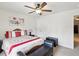 Bright bedroom with a ceiling fan, a chest, and a queen sized bed covered in colorful linens at 3455 Whispy Ct, Spring Hill, FL 34609