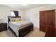 Cozy bedroom with a large bed, neutral-toned walls, and a closet for storage at 3455 Whispy Ct, Spring Hill, FL 34609