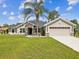 Well-maintained single Gathering home with fresh landscaping, decorative accents, and a two-car garage with a long driveway at 3455 Whispy Ct, Spring Hill, FL 34609