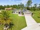 Charming single Gathering home showcasing a well-manicured lawn with decorative landscaping and a long driveway at 3455 Whispy Ct, Spring Hill, FL 34609