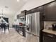 Well-appointed kitchen with stainless steel appliances and a view to dining and living area at 3455 Whispy Ct, Spring Hill, FL 34609