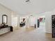 Spacious living room with neutral carpeting and open layout to dining area, perfect for entertaining at 3455 Whispy Ct, Spring Hill, FL 34609