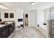 Bright bathroom with double sink vanity, soaking tub, and glass enclosed shower at 3455 Whispy Ct, Spring Hill, FL 34609