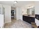 Main bathroom features double vanities, tile floors, and a glass shower enclosure at 3455 Whispy Ct, Spring Hill, FL 34609