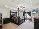 Opulent main bedroom featuring a tray ceiling, a ceiling fan, an en-suite bathroom, and custom curtains at 3455 Whispy Ct, Spring Hill, FL 34609