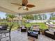 Covered patio area with comfortable seating, ceiling fan, and views of the backyard at 3455 Whispy Ct, Spring Hill, FL 34609