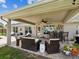 Charming covered patio with comfortable seating, ceiling fan, and an outdoor bar, perfect for entertaining guests at 3455 Whispy Ct, Spring Hill, FL 34609