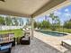 Beautiful backyard pool area with lounge chairs, a well-kept lawn, and secure fencing for privacy and relaxation at 3455 Whispy Ct, Spring Hill, FL 34609