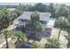 Aerial view of a coastal home nestled among palm trees, featuring a large deck for outdoor living at 3461 Gum Dr, Weeki Wachee, FL 34607