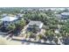 Aerial view of blue home and property with mature trees near the water at 3461 Gum Dr, Weeki Wachee, FL 34607