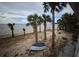 Backyard featuring sandy area, mature palm trees, and beautiful views of the bay at 3461 Gum Dr, Weeki Wachee, FL 34607